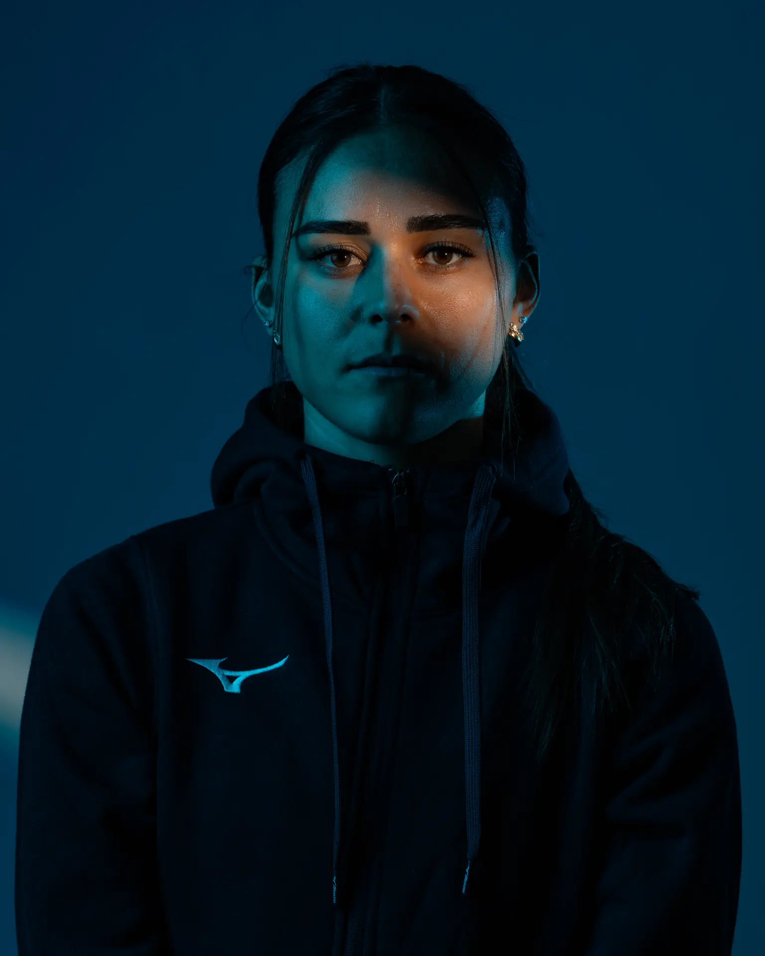 Moody blue editorial portrait photographed by Visuals Dennys